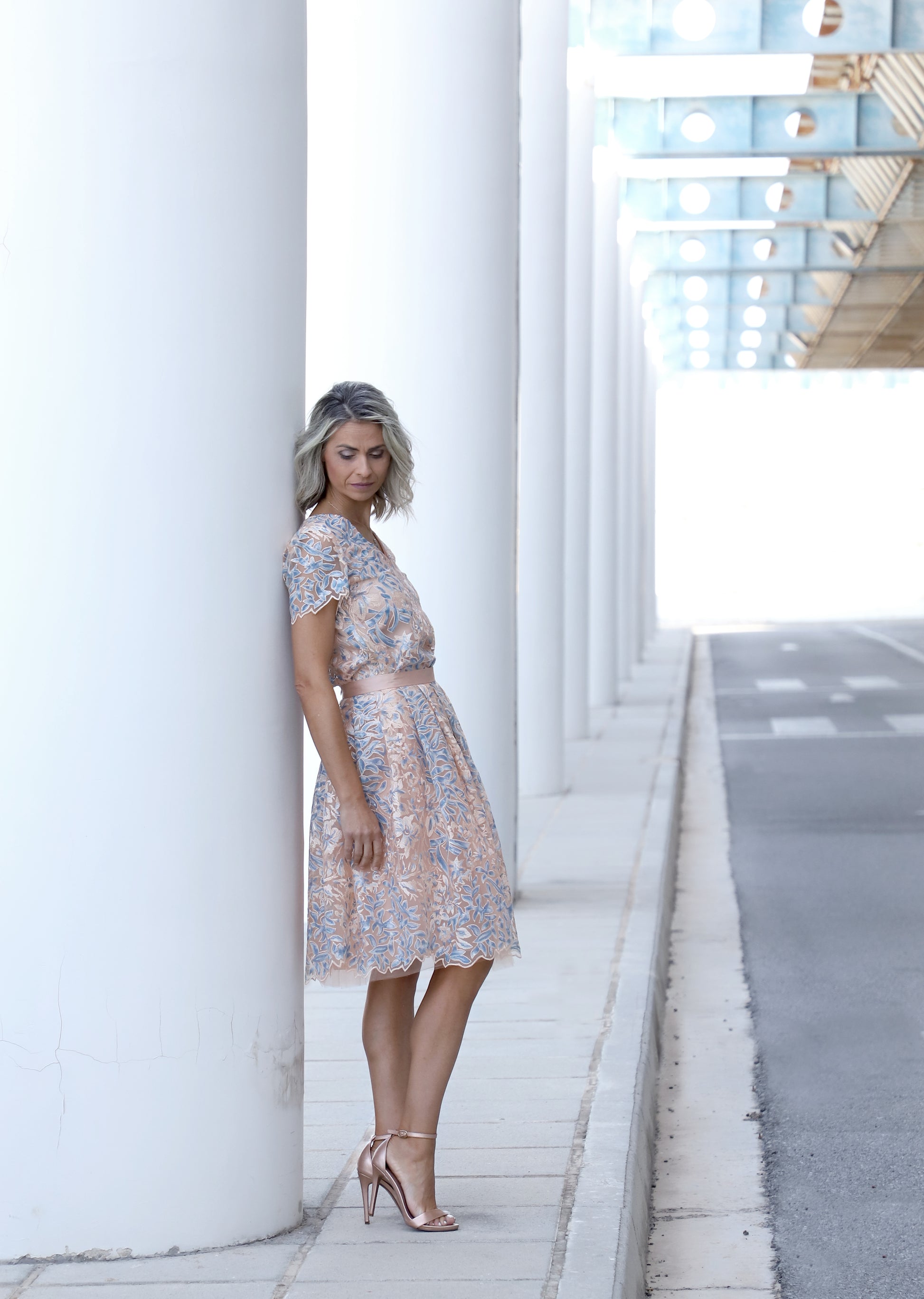 Side view of VVC blue floral sequin skirt set with soft salmon tone, knee-length A-line skirt and matching embroidered top