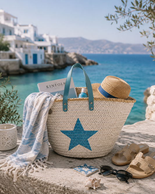 VVC handmade blue star beach basket styled by the sea in Sitia Crete with beach towel, sandals and summer holiday essentials