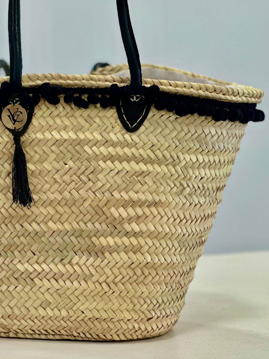VVC boho beach basket with black leather shoulder handles and white drawstring fall-out protection inlet, handmade summer tote for beach and travel