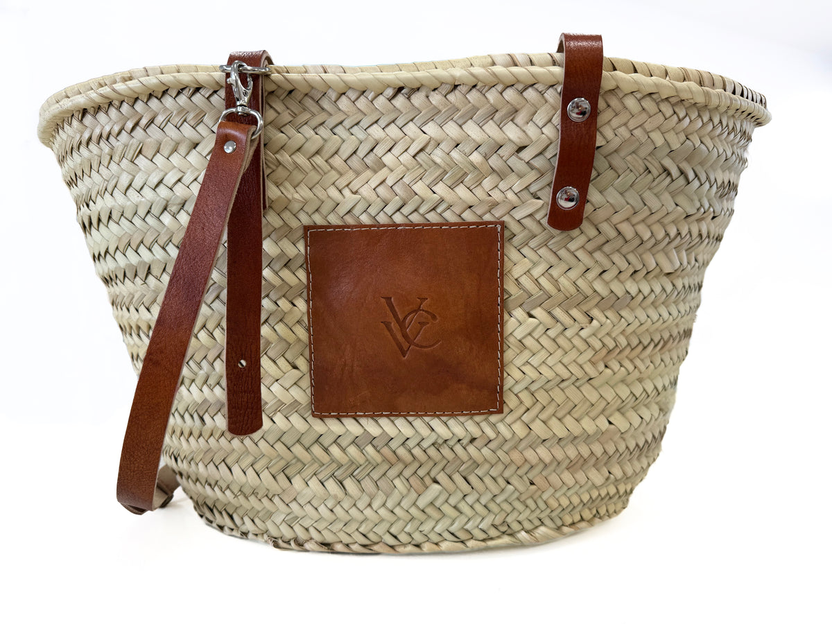 Handmade VVC™ crossbody palm leaf basket with brown leather strap and leather pocket. Lightweight shopping bag, beach tote and travel basket available in Sitia, Crete and online.