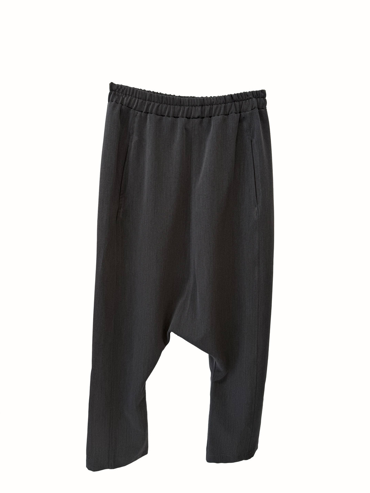 Flat-lay front view of VVC dark-grey harem trousers with tapered legs and a relaxed low-crotch cut.