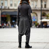 Back view of a woman wearing VVC dark-grey striped harem trousers with a relaxed low-crotch silhouette.