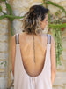 Close-up of the deep scoop back, metallic elastic shoulder straps and decorative pleats on the VVC Flowing Blush Midi Dress made in Greece.