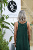 Rear angle showing longer back hem and elegant drape of VVC™ green sequin maxi dress, made in Greece.