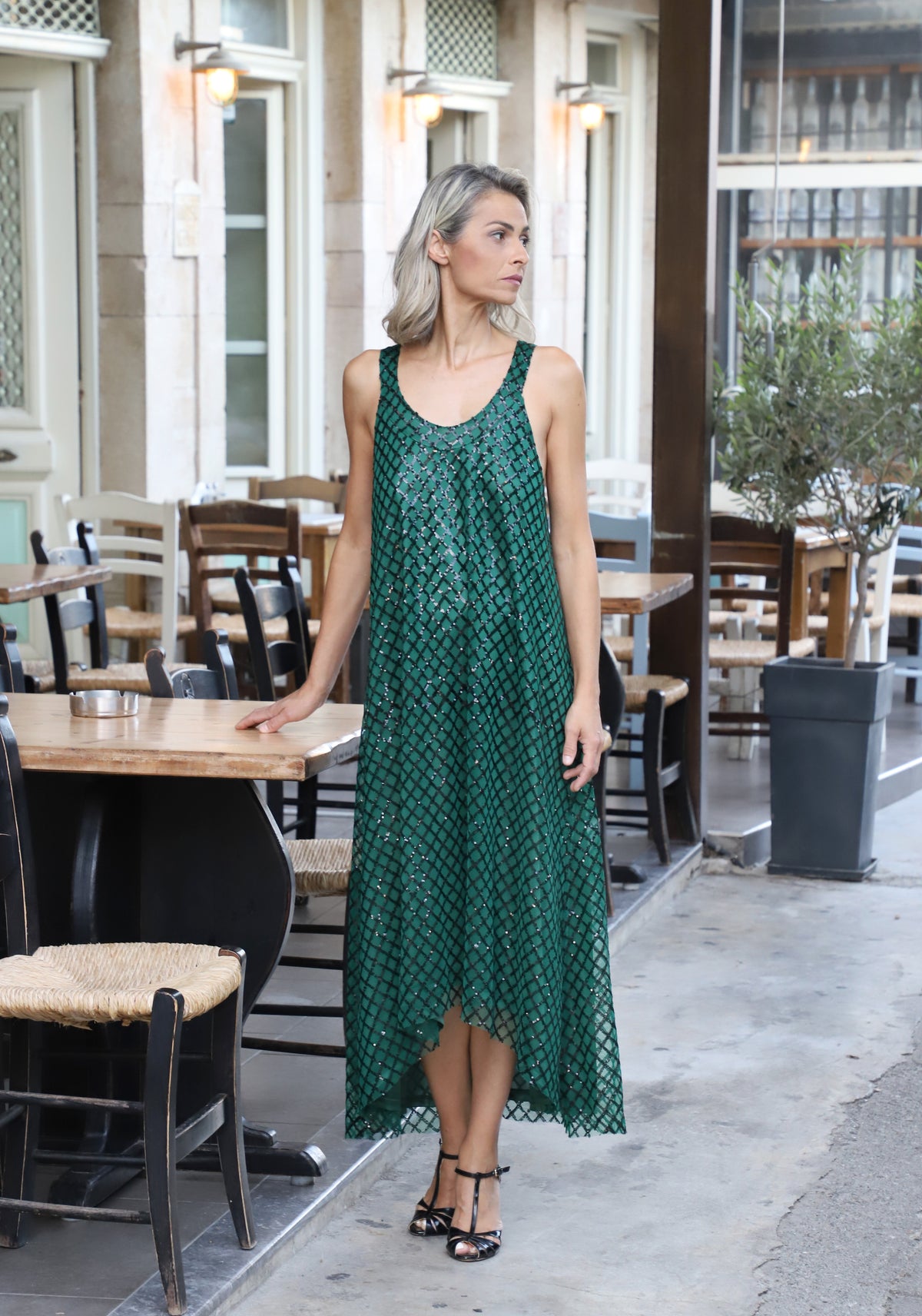 Close-up of VVC™ green sequin maxi dress showing fine fabric texture and sequin check pattern.