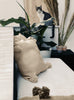 Beige VVC handmade cotton pillowcase with four decorative pom-poms styled on a sofa, 45 × 45 cm.