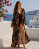 Lifestyle front view of VVC handmade black floral Italian silk kimono made from Dolce & Gabbana fabric, luxury resortwear in Crete Greece