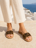 VVC™ handmade leopard leather sandals worn with ivory linen trousers in Crete – Mediterranean women’s summer fashion 2026.