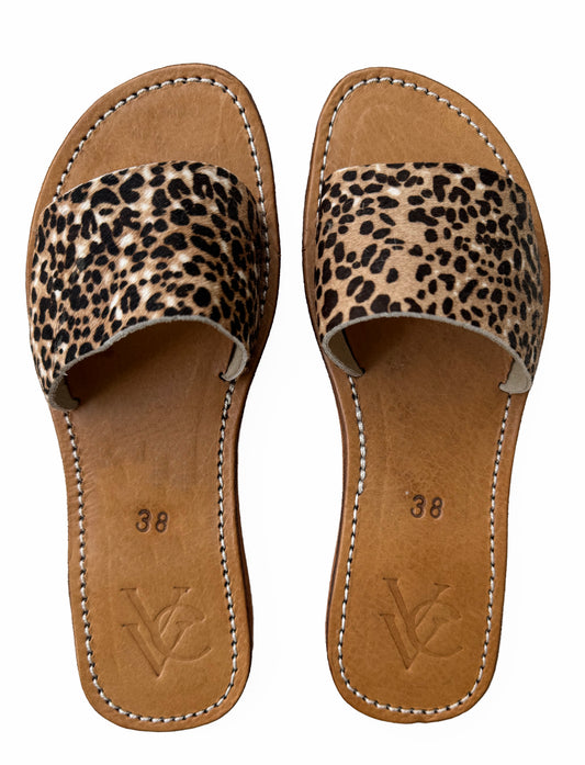 Top view of VVC™ handmade leopard print cowhide leather sandals with tan leather footbed and visible stitching, available online at viktoria-vigh.com