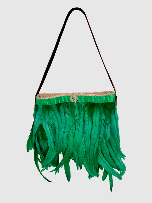 Front product view of the VVC handmade small raffia shoulder bag with green feathers and a slim shoulder strap.