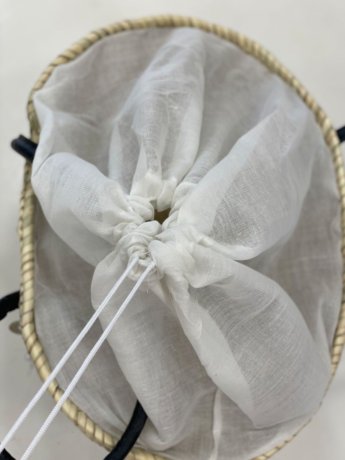White textile drawstring lining inside the VVC™ Kardia Heart Basket, designed to protect belongings and keep contents secure while adding practical everyday functionality.
