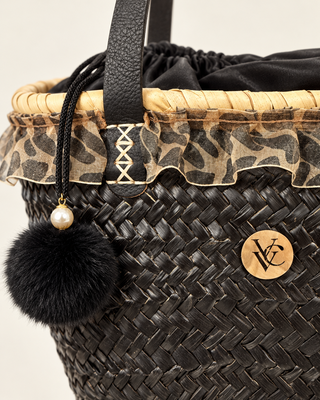 Close-up of black raffia weave and leopard-print lace detail on VVC™ basket bag