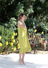 Side view of the VVC lime green flowing midi dress styled for summer resort wear in Greece