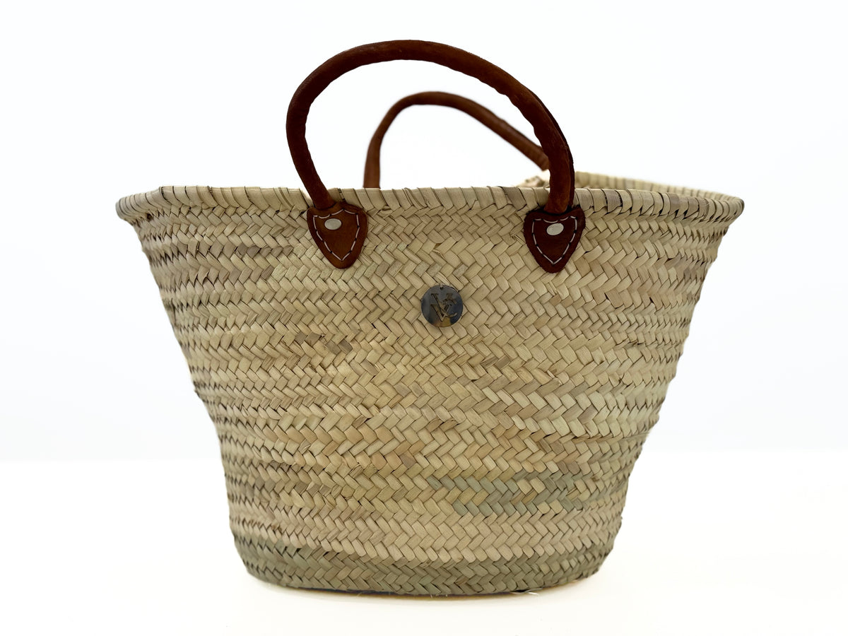 Handmade natural palm leaf basket used as stylish kitchen storage for bread, vegetables and everyday home organization.