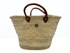Handmade natural palm leaf basket used as stylish kitchen storage for bread, vegetables and everyday home organization.