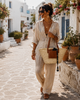 Handmade VVC™ woven palm leaf basket with leather pocket and leather handles, styled for storage, laundry and home décor in a Mediterranean interior setting.