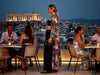Side view of the VVC Pink Animal Print Long Silk Kimono Cardigan made from 100% Italian silk and styled for an elegant rooftop evening in Greece