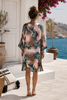 Back view of the VVC pink silk cardigan, showing the soft pink tropical leaf and leopard print, relaxed straight cut and knee-covering length.