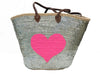 Large handmade silver sequin beach basket with bright neon pink heart applique, brown leather handles and palm leaf structure. Stylish luxury beach bag for women, perfect for holidays in Greece, shopping and resort fashion.