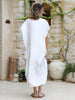 Back view of the VVC white kaftan dress showing the flowing maxi silhouette and relaxed drape