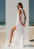 Walking side view of the VVC white cotton maxi dress with flowing movement