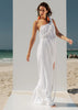 Walking view of the VVC white cotton resort maxi dress with flowing silhouette and high slit