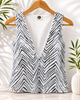 Black and white zigzag patterned sleeveless top on a wooden hanger with a neutral background VVC Sitia.