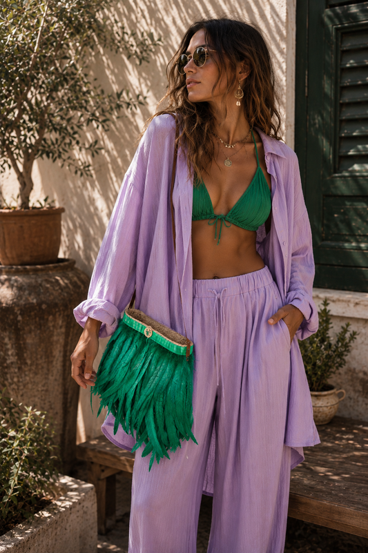 VVC™ handmade green feather raffia shoulder bag styled with a lavender boho outfit in Sitia, Crete, showcasing luxury Greek island fashion for summer 2026.