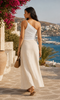 Open-shoulder side view of a white asymmetric ruched women’s summer top styled in Crete, available at VVC Shop Sitia and online.