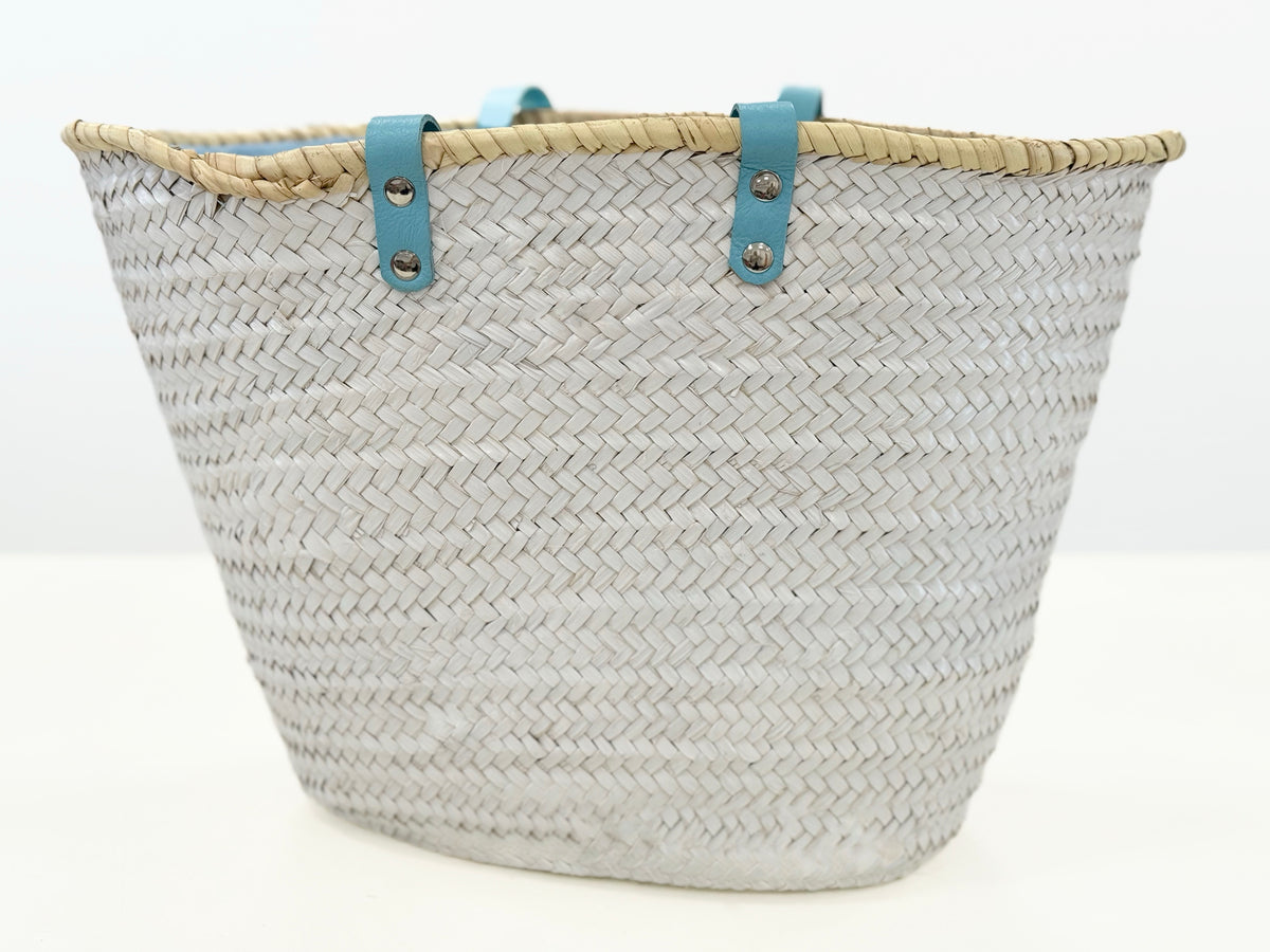 Back view of VVC handmade raffia beach basket with turquoise leather handles and spacious beach storage