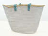 Back view of VVC handmade raffia beach basket with turquoise leather handles and spacious beach storage