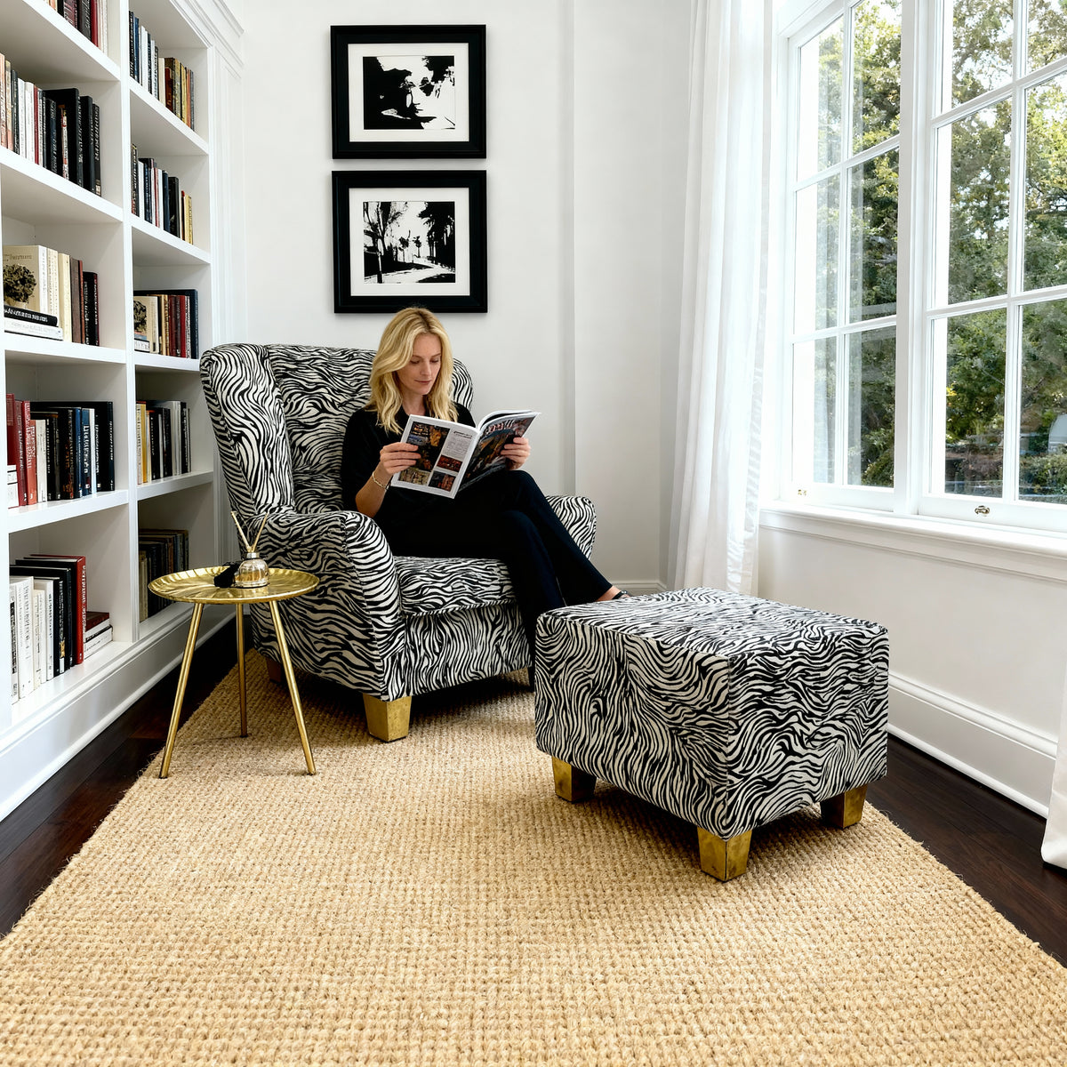 Brass-leg zebra cowhide stool used as accent seating near coffee table in modern living room