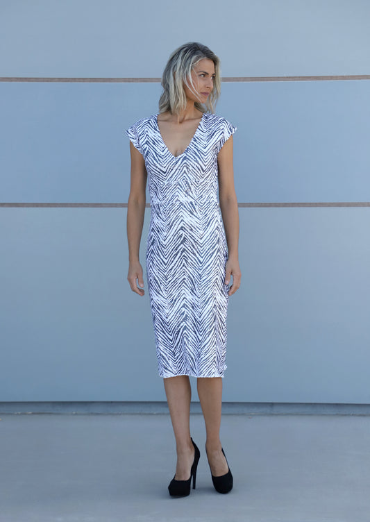 Side view of VVC TM zebra sheath dress with long slit, elegant evening wear at THE VVC SHOP SITIA Black Friday offer.