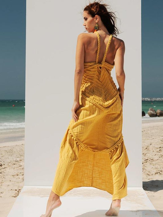 Back view of the Zoe Artemis mustard-yellow cotton-crepe maxi dress showing its braided straps, folded waist detail and asymmetric hem.