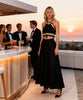 Zoe the Label black gold macramé top styled for a luxury resort evening look with backless tie design and gold metal details VVC Shop Sitia