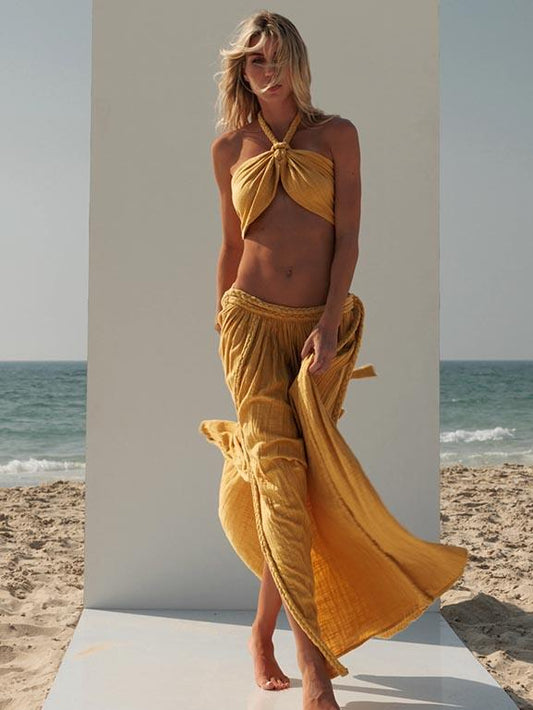 Full-length front view of the ZOE Zena mustard-yellow cotton-crepe set with a braided halter crop top and matching low-waist maxi skirt.